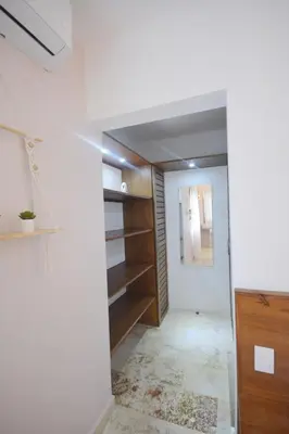 a hallway with wooden shelves and a white wall at House with pool 300 m from Las Ballenas beach in Las Terrenas