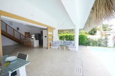 a living room with a couch and a table at House with pool 300 m from Las Ballenas beach in Las Terrenas