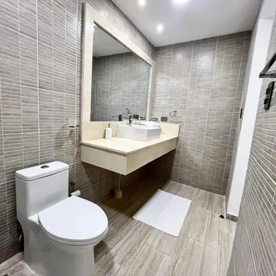 a bathroom with a toilet and a sink and a mirror at Maple Beach, apartamento en Punta Cana in Punta Cana