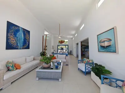 a living room with couches and a table at Luxury Oceanfront Villa with Heated Pool, Jacuzzi, AC, BBQ, Starlink Wi-Fi, Chef's Kitchen, Staff Included, Mountain Views, Near El Quemaito, San Rafael, and Los Patos Beach in Santa Cruz de Barahona
