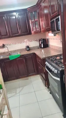 a kitchen with wooden cabinets and a stove top oven at My hogar in Colorado