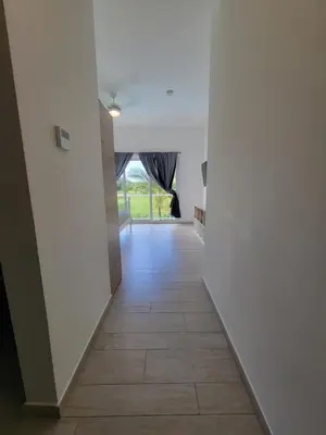 a hallway with white walls and a tile floor at Modern 2BDR - Pool & Golf View in Punta Cana