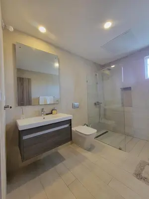 a bathroom with a sink and a shower and a toilet at Modern 2BDR - Pool & Golf View in Punta Cana