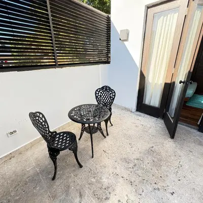 three chairs and a table on a patio at Casa De Mabel in Santo Domingo