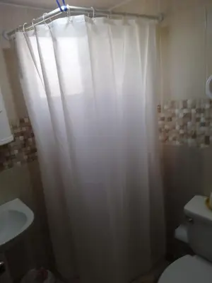 a white shower curtain in a bathroom with a toilet at Hermoso Apartamento Turístico in Colorado