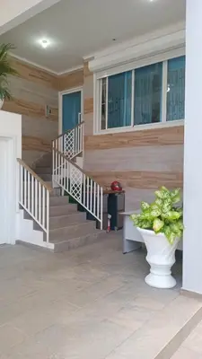 a staircase in a house with a vase on the floor at Cozy apartment in Boca Chica in Boca Chica
