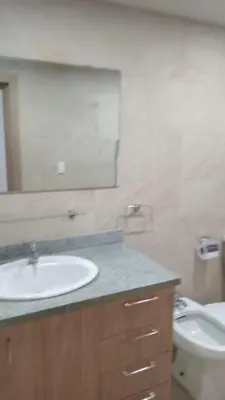 a bathroom with a sink and a mirror and a toilet at Cozy apartment in Boca Chica in Boca Chica