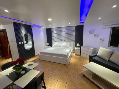 a bedroom with a bed and a couch and a table at Juan Dolio paradise in Villas del Mar
