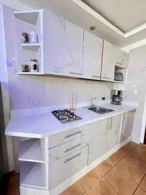 a white kitchen with a sink and a stove at Juan Dolio paradise in Villas del Mar