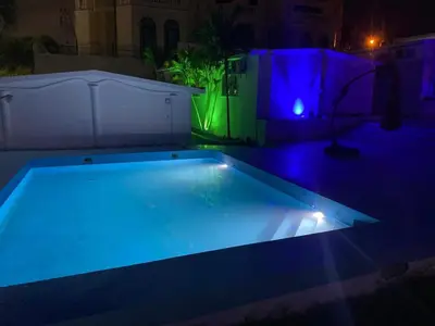 a swimming pool with blue and green lights at Hannabi Hotel in Boca Chica