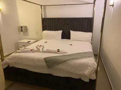 a bedroom with a bed with two swans on it at Hannabi Hotel in Boca Chica