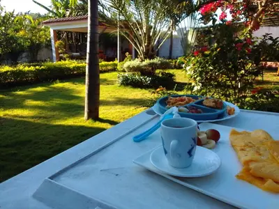 a table with a plate of food and a cup of coffee at Villa Dupi in Colorado