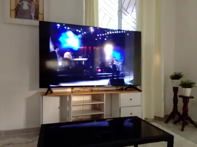 a large flat screen tv on a stand in a living room at Villa Dupi in Colorado