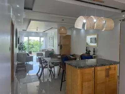 a kitchen and dining room with a table and chairs at Beach and comfort in Las Terrenas