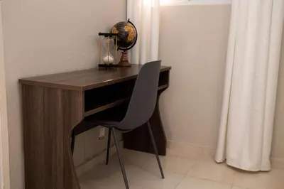 a wooden desk with a chair in a room at Luxury 2 bedroom Apartment in Santiago de los Caballeros
