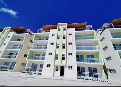 a tall white apartment building with a blue sky in the background at Luxury apartment in Cabrera in Cabrera