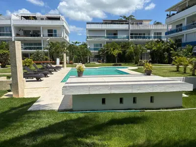 a swimming pool in front of a large building at Apartment en residence face à la Mer in Las Terrenas