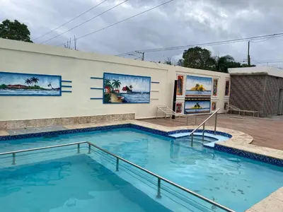 a swimming pool in front of a building at Villa Hotel Saul & Lucas in Castillo