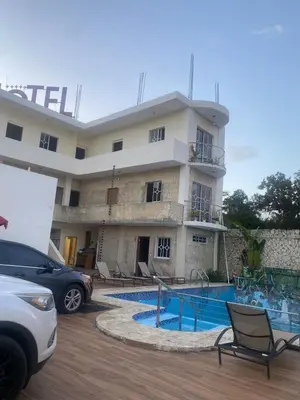 a building with a swimming pool in front of a building at Villa Hotel Saul & Lucas in Castillo