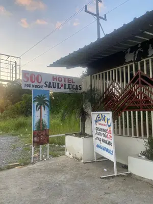 a sign for a hotel with a palm tree on it at Villa Hotel Saul & Lucas in Castillo