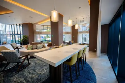 a lobby with a large table and chairs at Hotel Hampton By Hilton Santiago De Los Caballeros in Santiago de los Caballeros