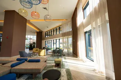 a lobby with a couch and chairs and windows at Hotel Hampton By Hilton Santiago De Los Caballeros in Santiago de los Caballeros