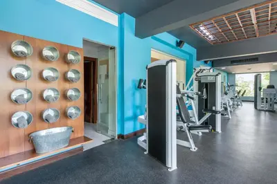 a fitness room with blue walls and a gym at Emotions by Hodelpa - Juan Dolio in Juan Dolio