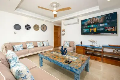 a living room with a couch and a table at Upper-Level Penthouse, Beachfront Residence in Las Terrenas