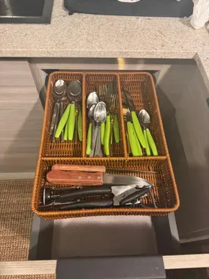 a wicker basket with utensils in a drawer at Private Lux Oasis, Vista Cana, Punta Cana in Punta Cana