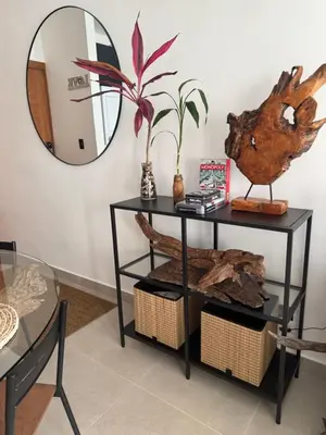 a black console table with a mirror on the wall at Private Lux Oasis, Vista Cana, Punta Cana in Punta Cana