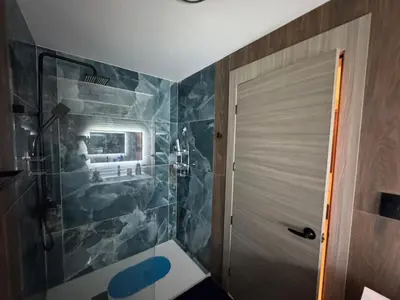 a bathroom with a shower with blue tiles at Private Lux Oasis, Vista Cana, Punta Cana in Punta Cana