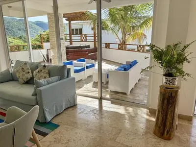 a living room with a couch and chairs and a patio at Beautiful apartment with sea view in Las Terrenas