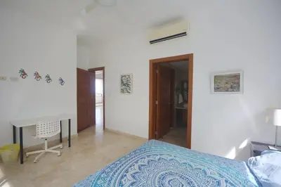 a bedroom with a bed and a desk in it at Beautiful apartment with sea view in Las Terrenas