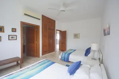 a bedroom with two beds and a swimming pool at Beautiful apartment with sea view in Las Terrenas