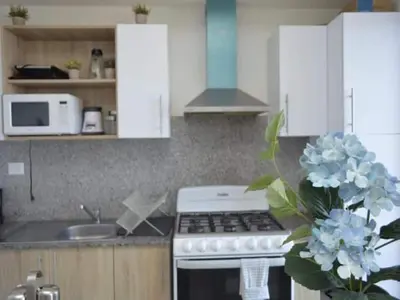 a kitchen with white cabinets and a stove top oven at Relaxing Ocean View Getaway in Boca Chica501 in Boca Chica