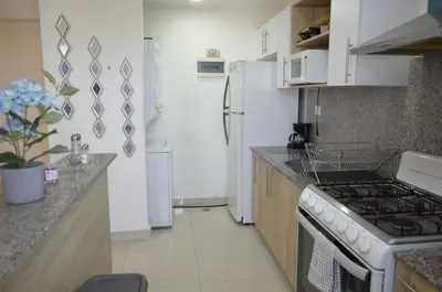 a kitchen with a stove and a white refrigerator at Relaxing Ocean View Getaway in Boca Chica501 in Boca Chica