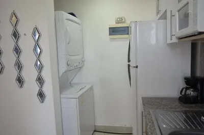 a kitchen with a refrigerator and a washer and dryer at Relaxing Ocean View Getaway in Boca Chica501 in Boca Chica
