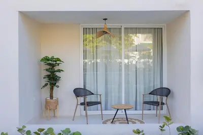 two chairs and a table in front of a window at Xanadú in Sampiño