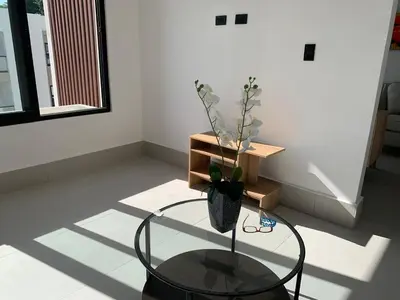 a room with a glass table with a vase on it at Prado Suites Luxurious Apartment for Long Term Stay in Las Terrenas