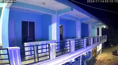 a building with blue walls and white railings at Alexel Property