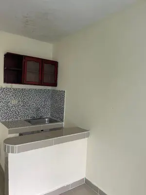 a kitchen with a sink and a counter top at Alexel Property