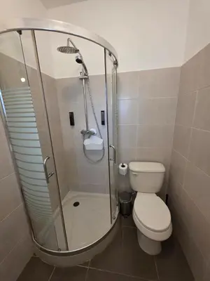 a bathroom with a toilet and a glass shower at Serenity Dominicus in La Laguna