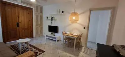 a living room with a small table and a television at Serenity Dominicus in La Laguna