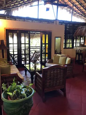 a living room with a couch and a table and chairs at Hotel El Rancho Sosua in Sosúa
