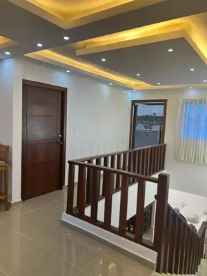 a lobby with a staircase and a wooden door at Residencial Pancho III in Los Mameyes