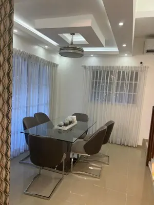a dining room with a glass table and chairs at Residencial Pancho III in Los Mameyes