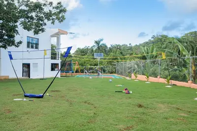 a park with a volley ball court and a playground at VILLA LEMON Samaná in El Limón
