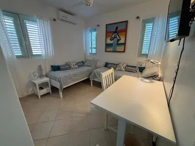 a living room with a couch and a table at Waterfront apartment in Las Terrenas