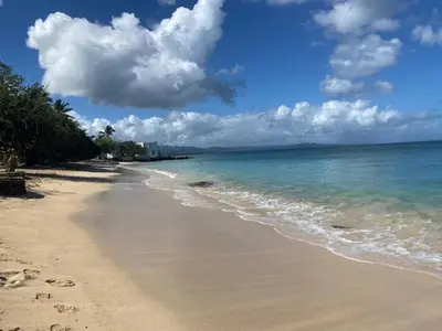 a beach with the ocean and clouds in the sky at Room 4 in Río San Juan