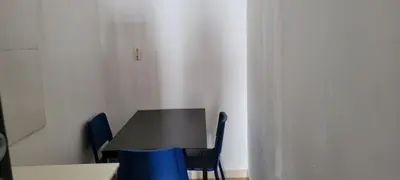 a black table and blue chairs in a room at Room 4 in Río San Juan